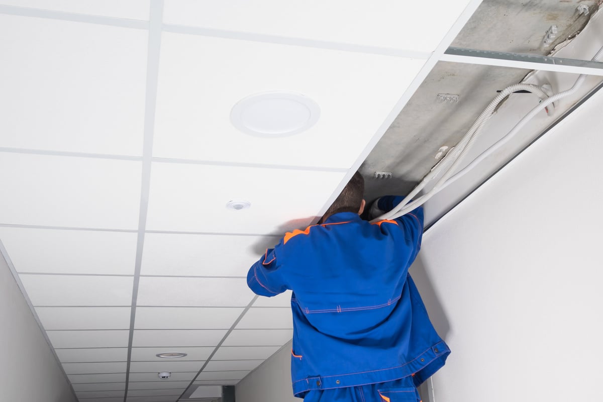 the master adjusts the electrical equipment above the false ceiling